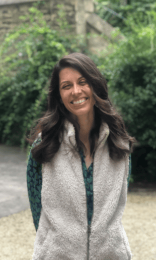 A woman with long, dark hair smiles